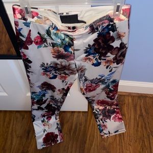 White suit pants with floral print.